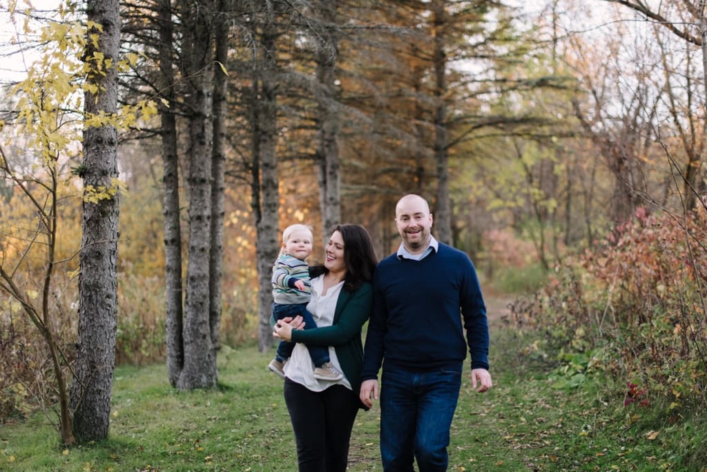 family fall session walking together in woods