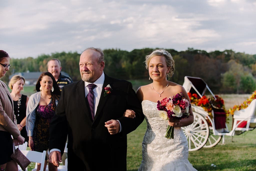 bride arrives at wedding in horse drawn carriage