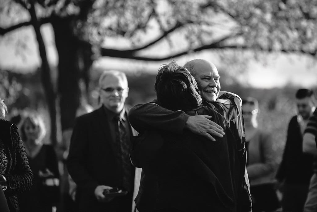 guests hug at outdoor wisconsin wedding