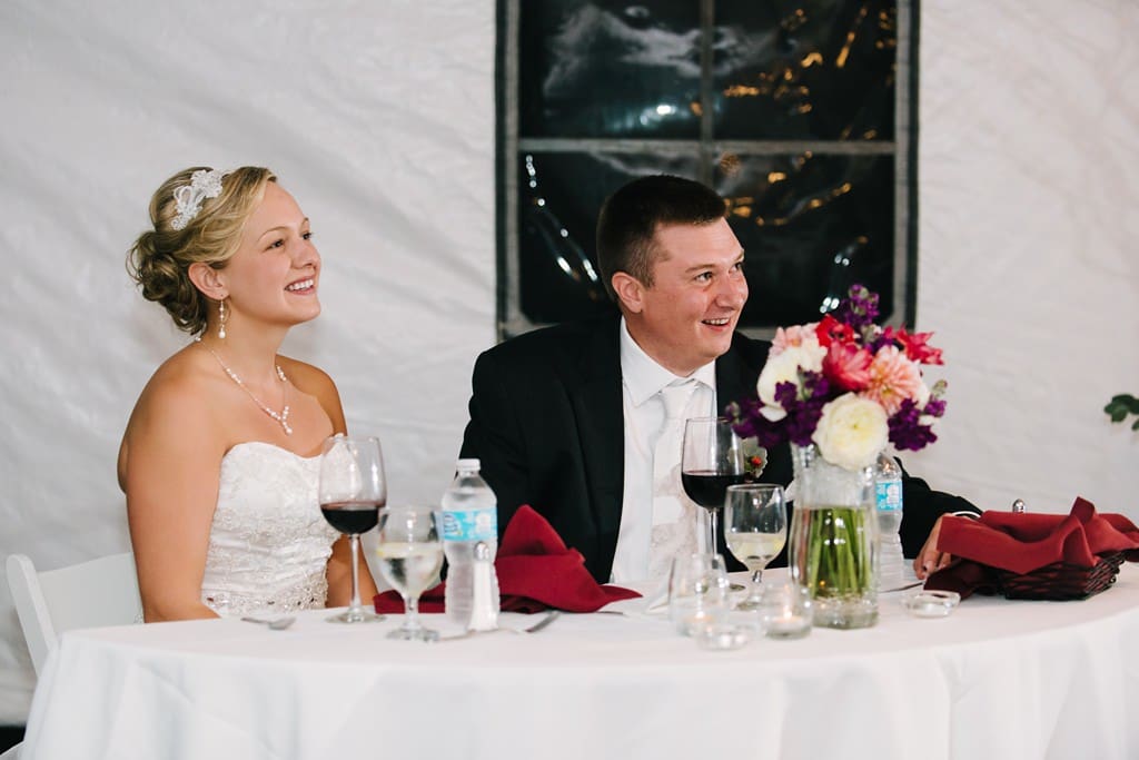 bride and groom listen to speeches at winery wedding