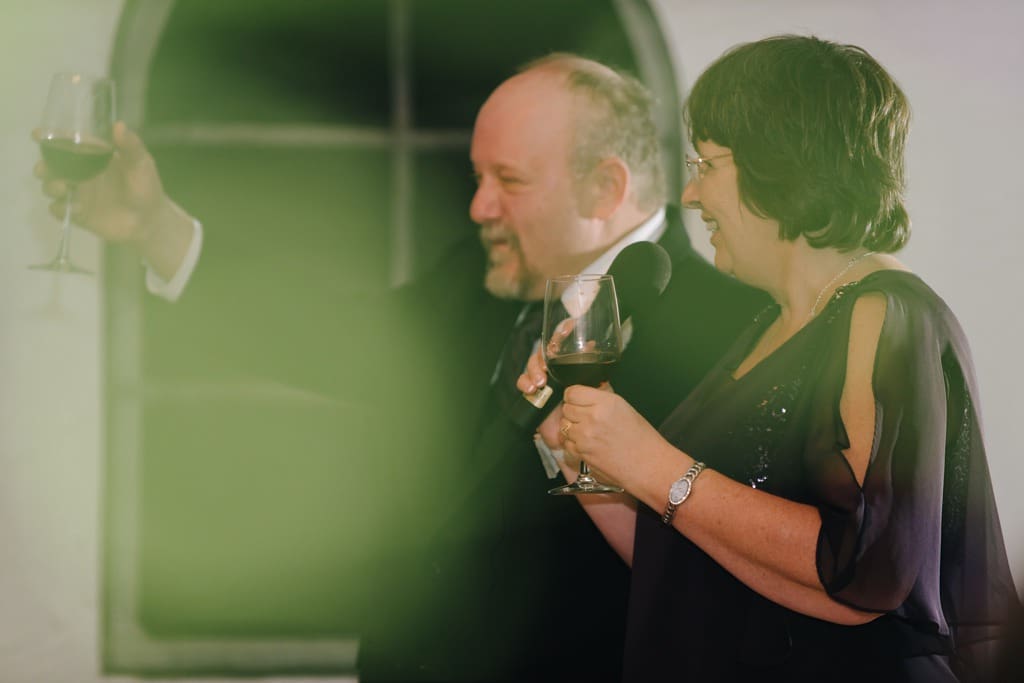 parents toast bride and groom at wedding reception