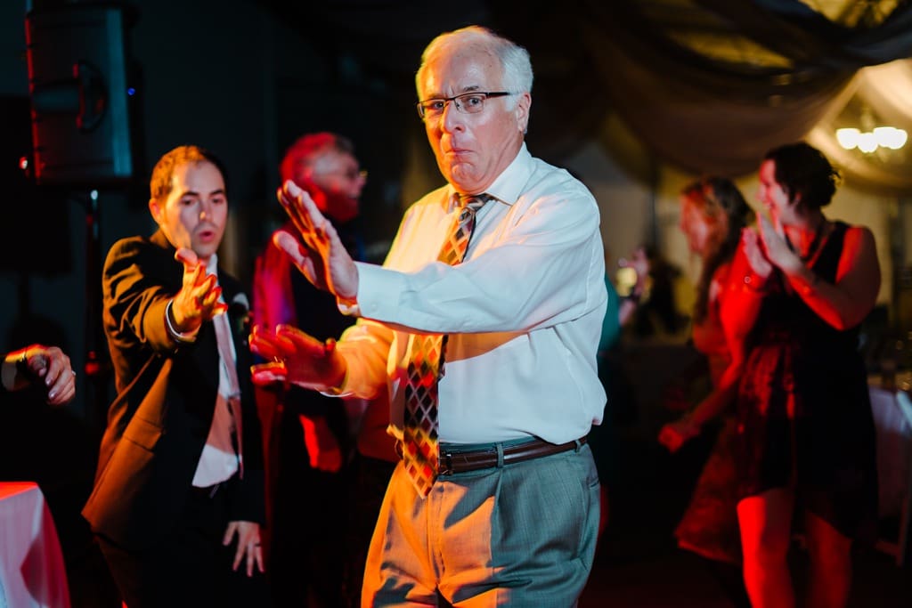 dancing at wedding reception with orange lights