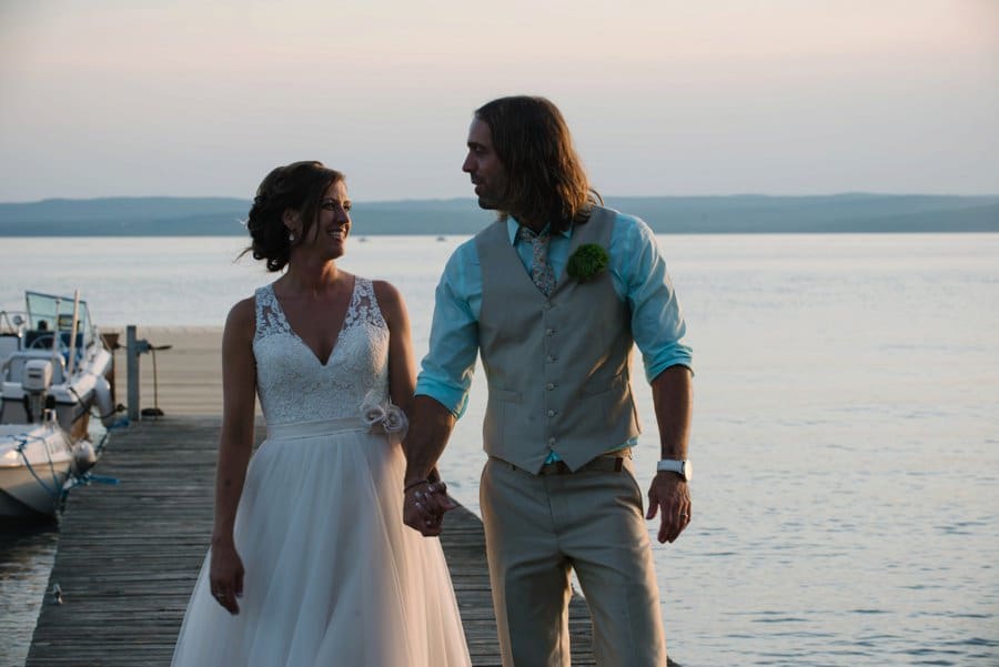 Madeline Island Wedding at Lake Superior Couple Walking in the Dock
