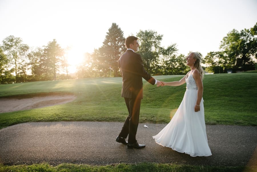 Bride and groom dancing in the sunset