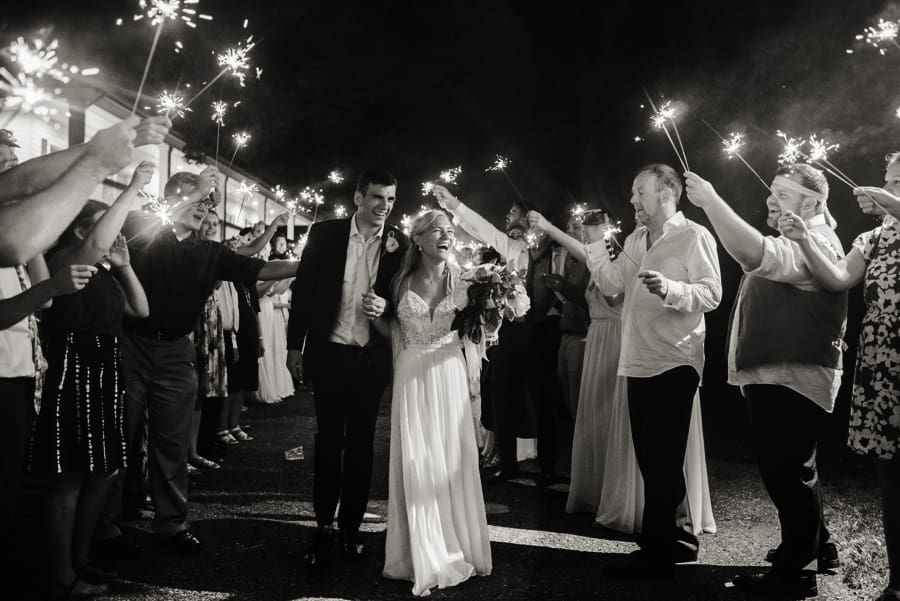 bride and groom leaving reception under sparklers