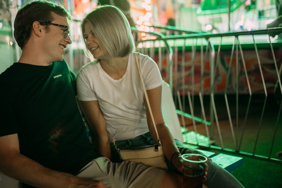 minnesota state fair couple sharing a moment next to the rides