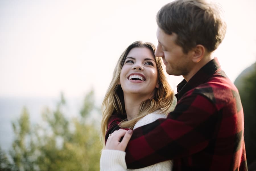 woman laughing over shoulder at fiance