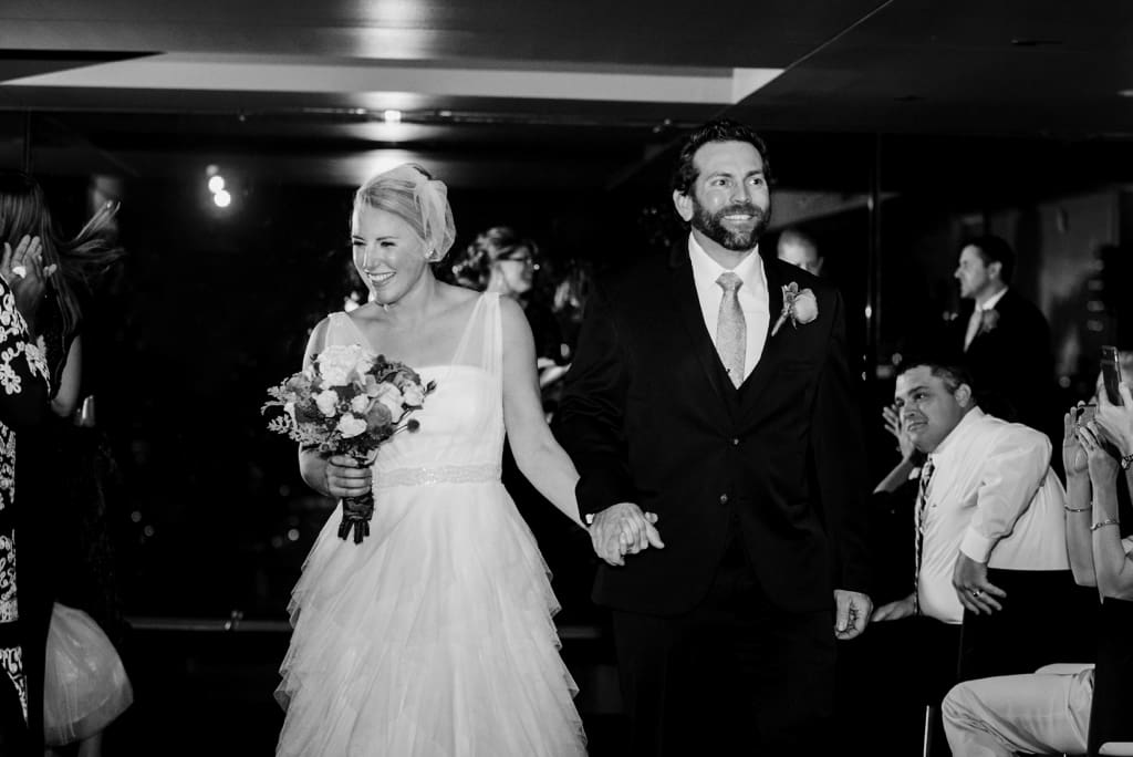 Minneapolis wedding bride and groom exit the ceremony happily