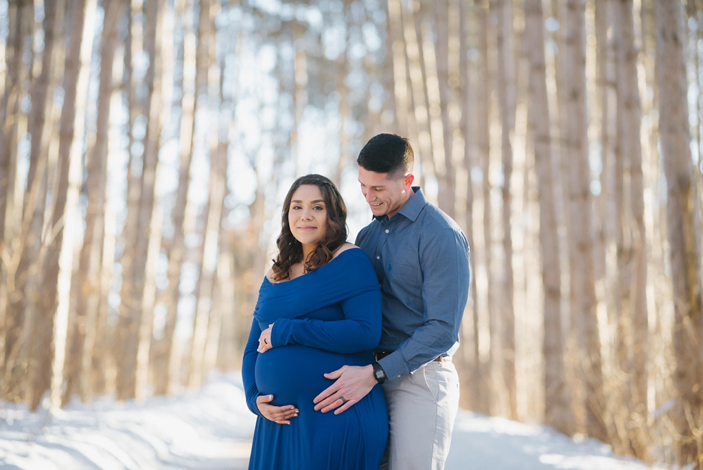 pregnant woman and husband in minnesota forest