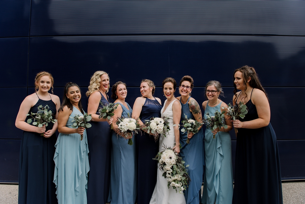 bride and bridesmaids laugh together for portrait