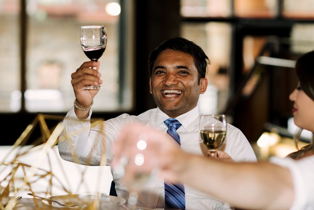 wedding guests toasting at reception