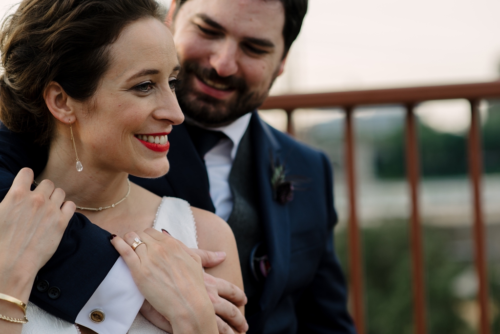 newlyweds embracing on minneapolis bridge after wedding