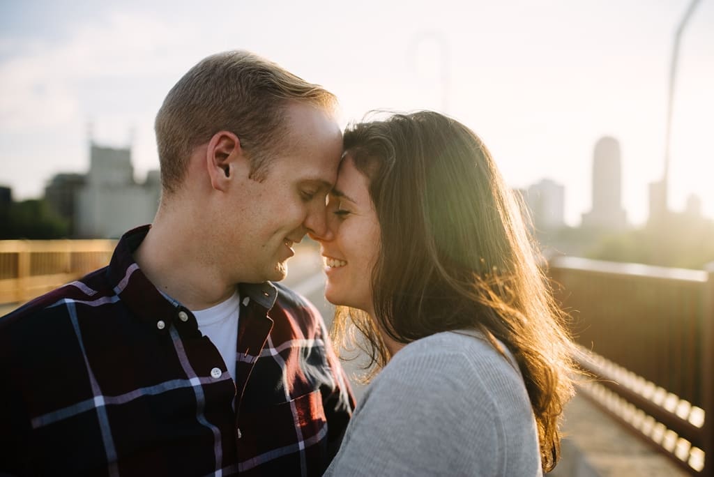 couple touching foreheads on minneapolis minnesota bridge
