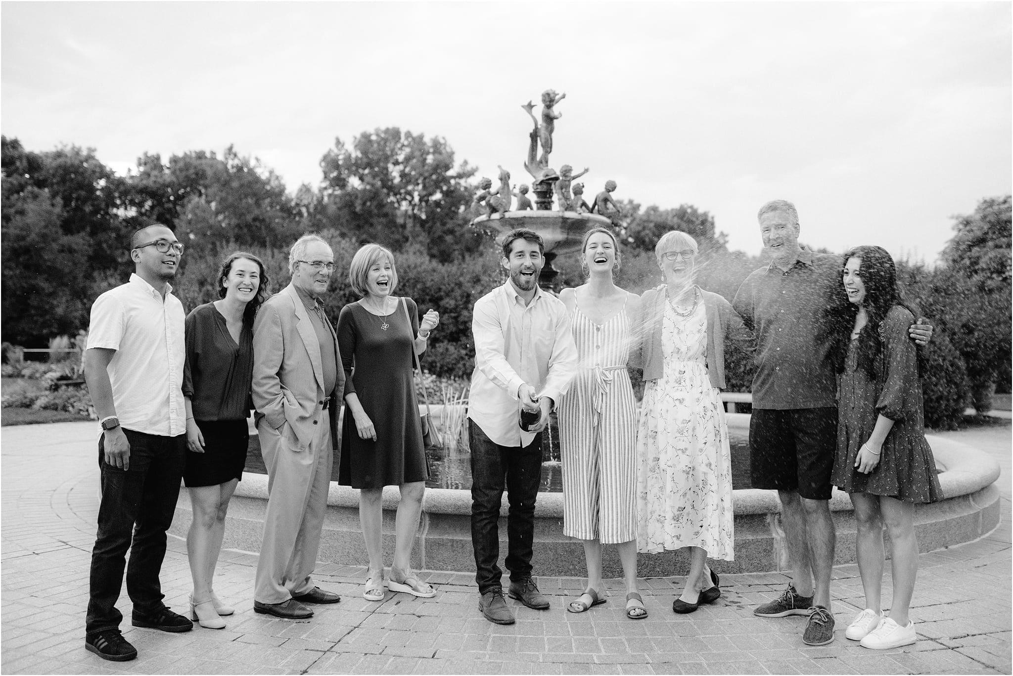 newly engaged couple celebrating with family
