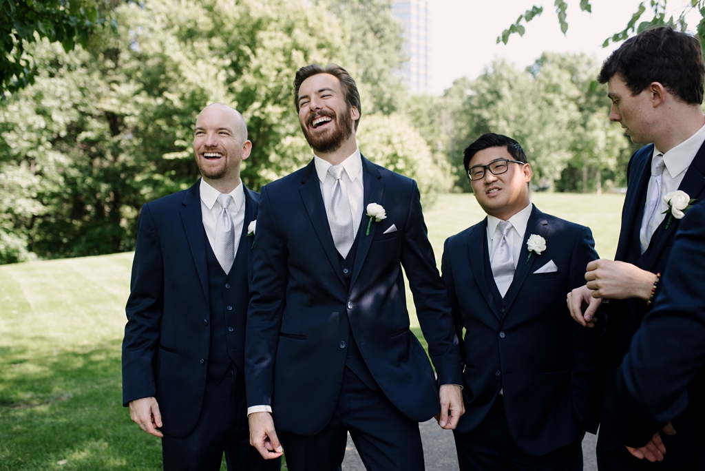 groom laughs with groomsmen
