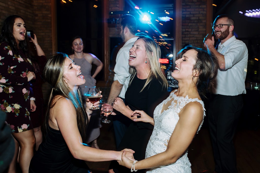 bride sings along and dances with wedding guests