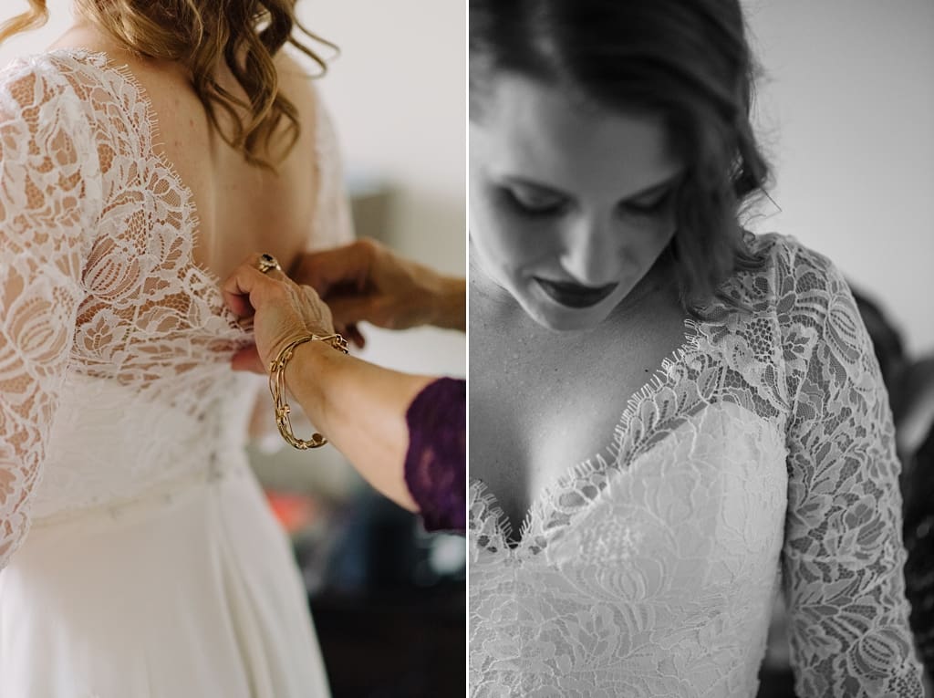 bride being fastened into wedding dress