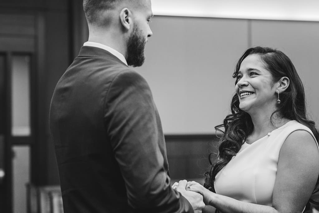 bride and groom exchanging vows at city hall