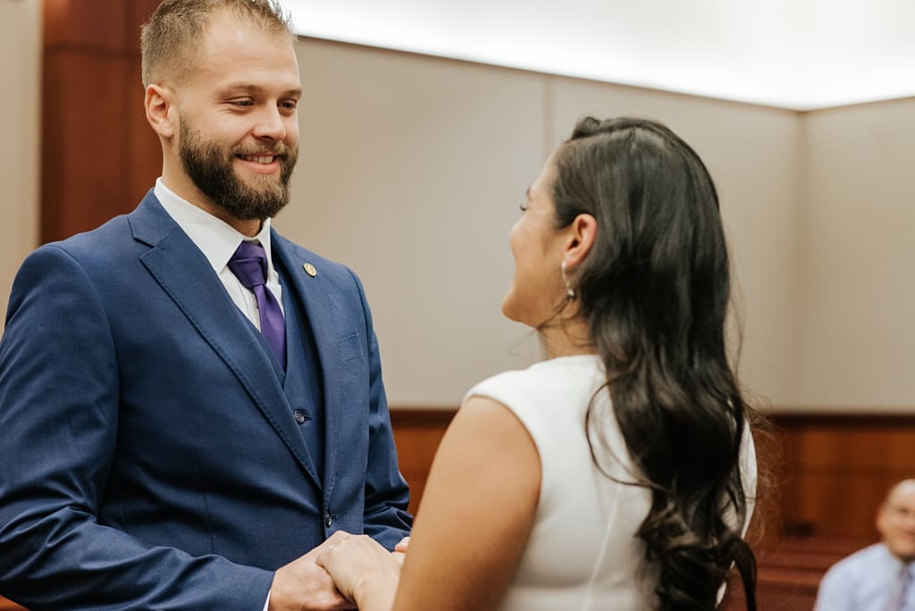groom smiling at bride
