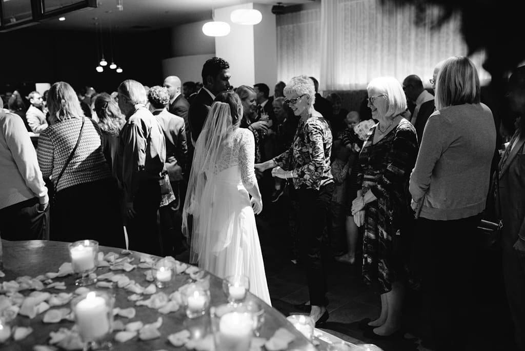 bride and groom with guests at wedding reception