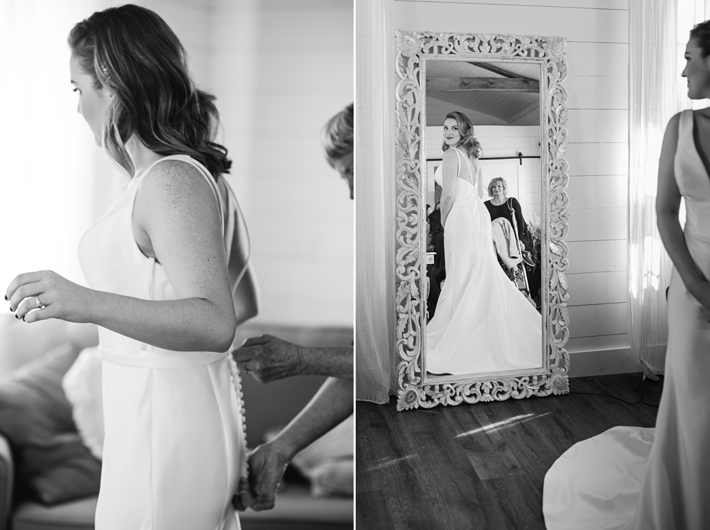 bride admiring self in wedding dress before minnesota wedding