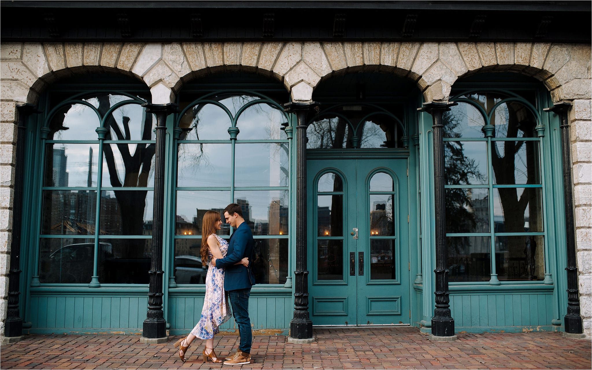 Couple hugging in St Anthony Main engagement photos