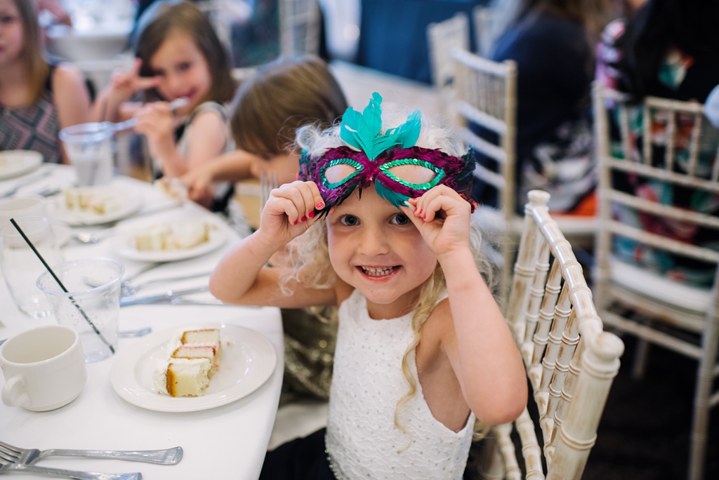 flower girl eats cake at minneapolis golf club reception