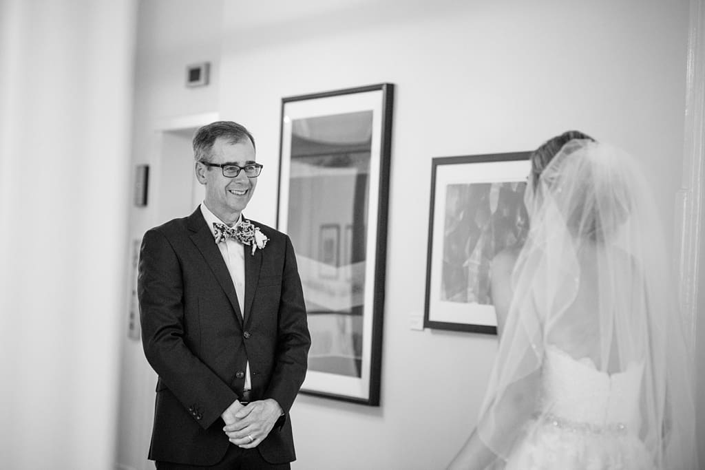 father of bride seeing daughter's dress