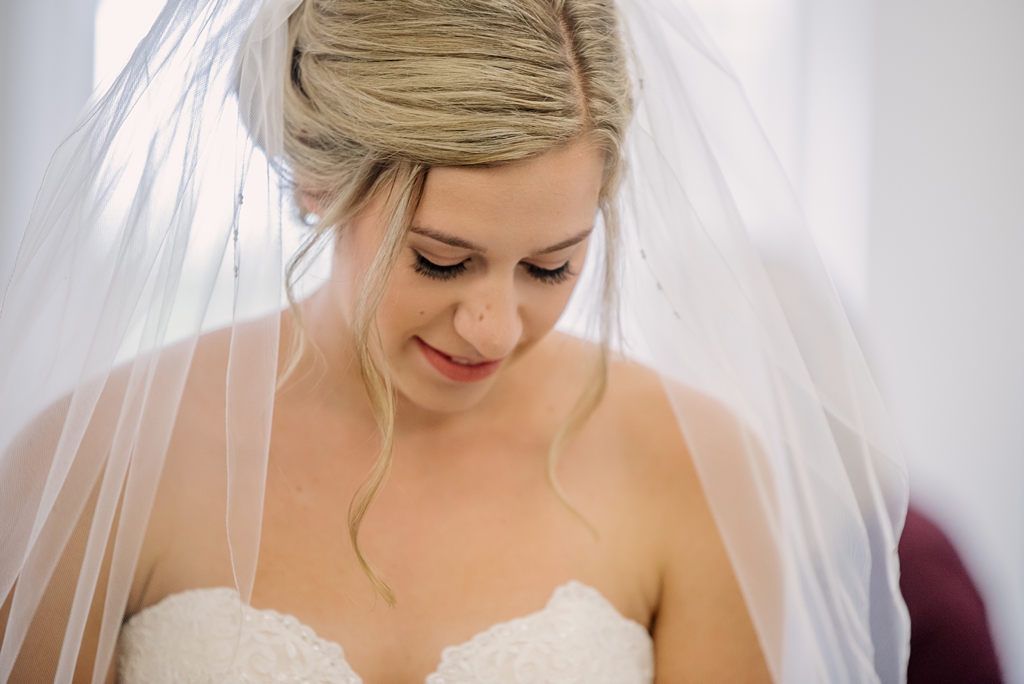 bride getting ready with veil and dress