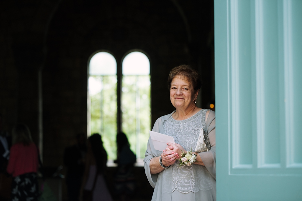 woman smiling out chapel's doors