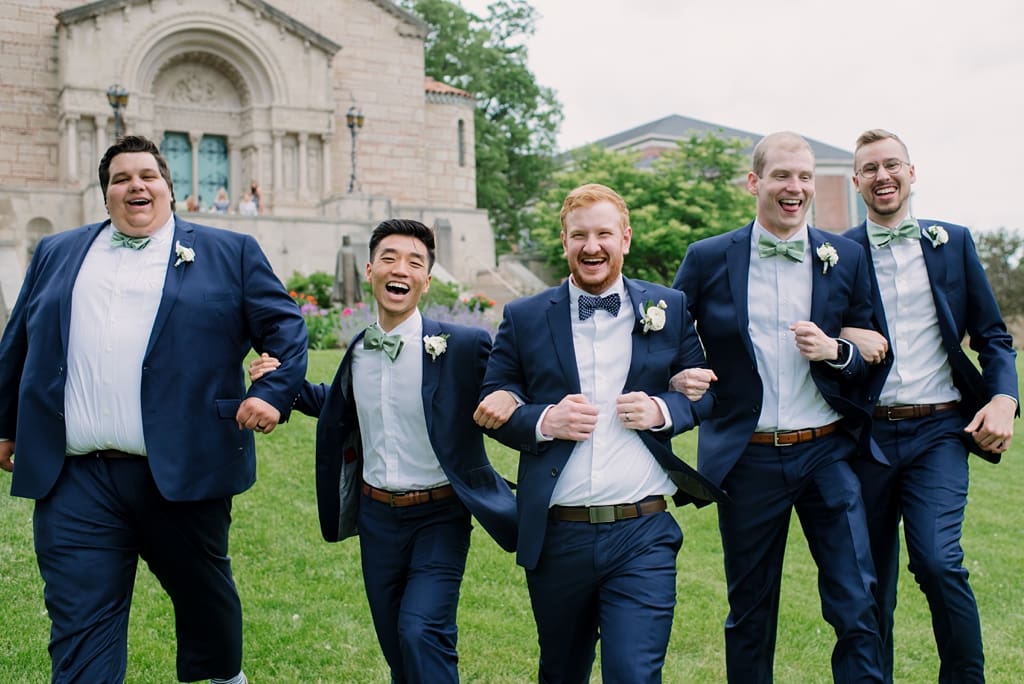 groom arm in arm with groomsmen