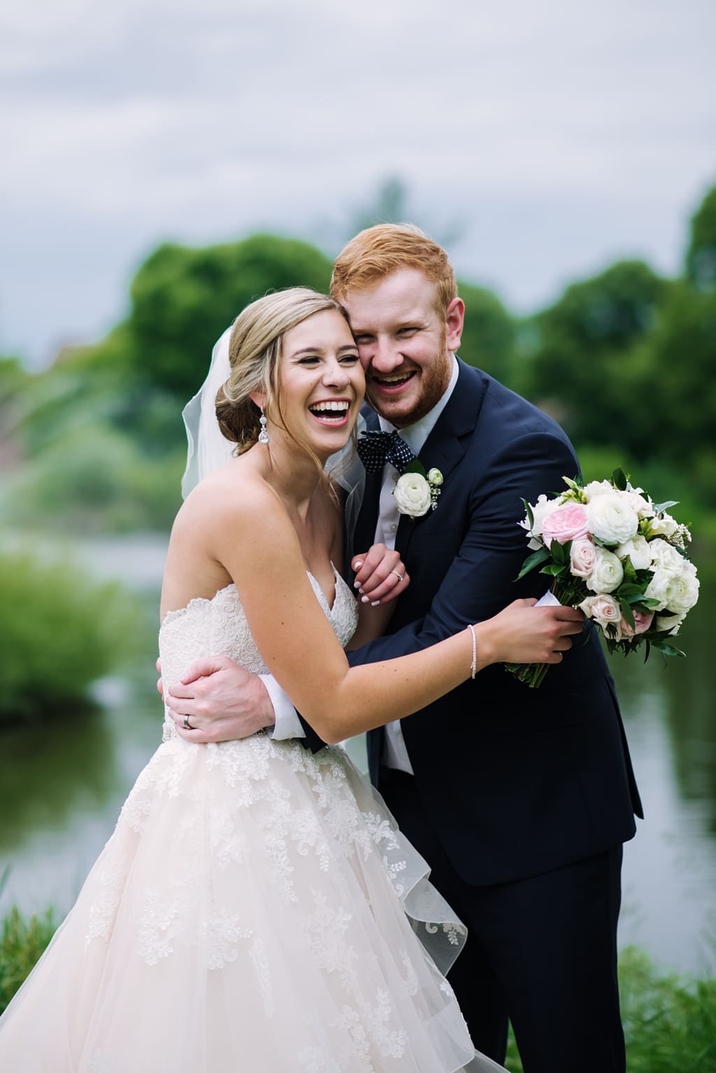 newlyweds laughing together during portraits