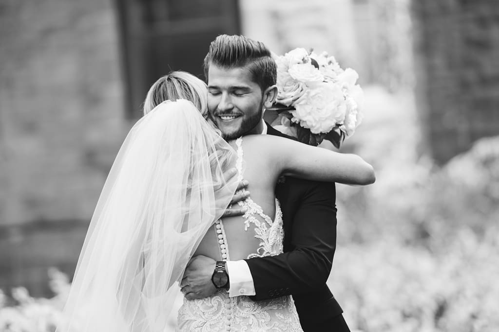 groom hugging bride during first look