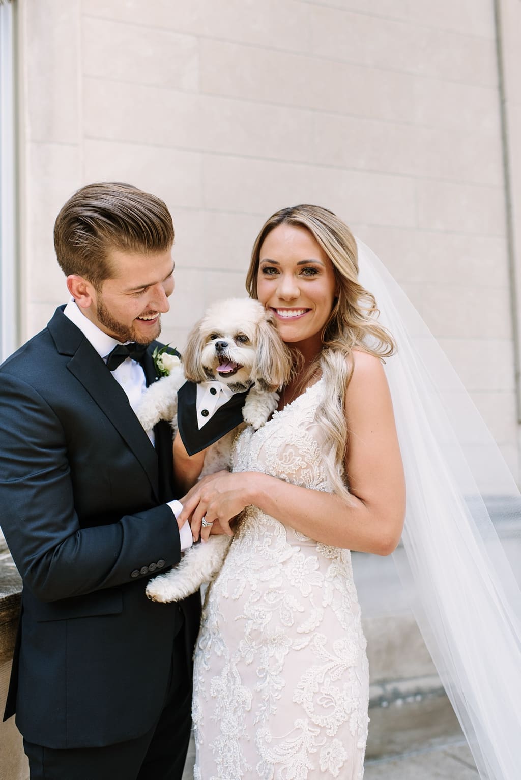 bride and groom pose with dog
