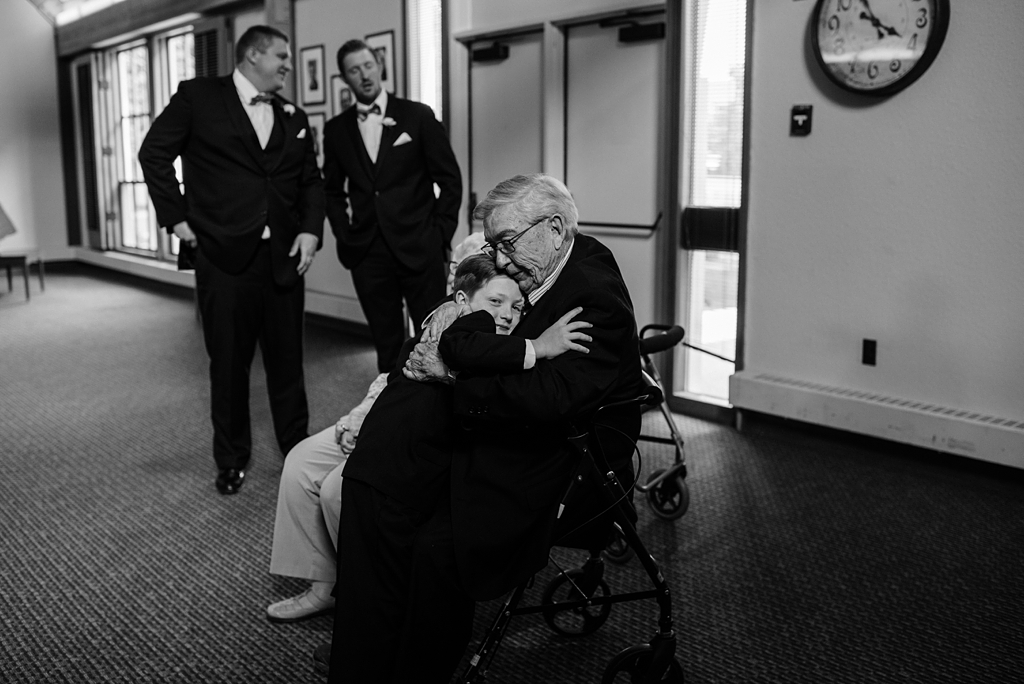 boy hugs elderly man at gale mansion event center wedding