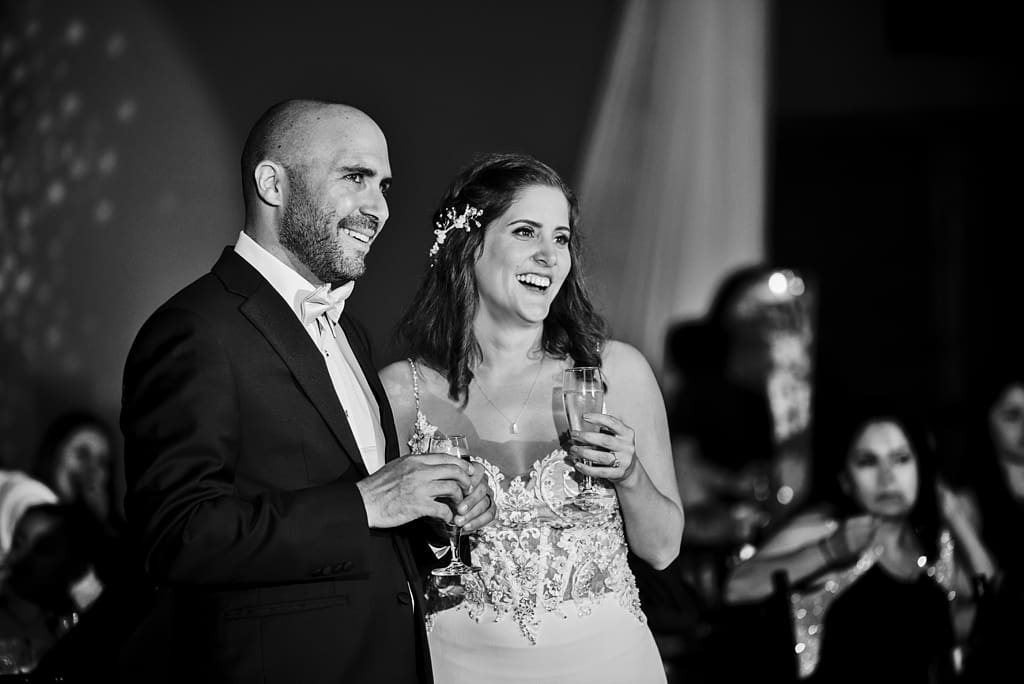 bride and groom during cannon river wedding reception toasts