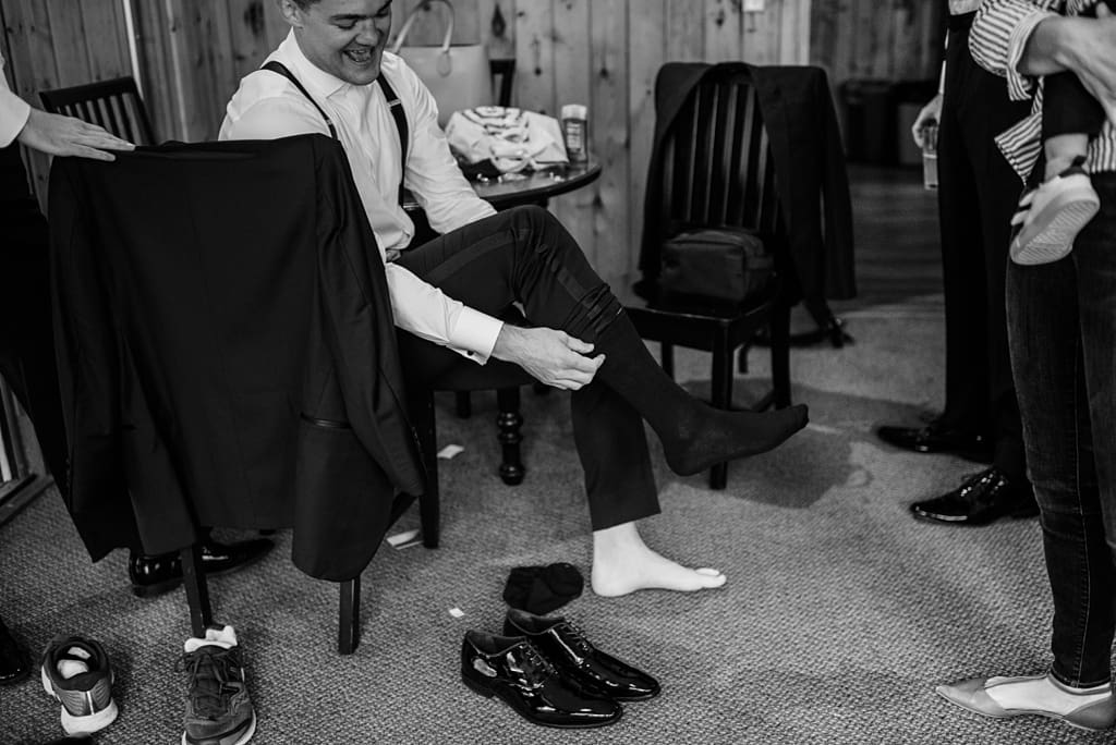 groom and groomsmen getting ready for lodge wedding