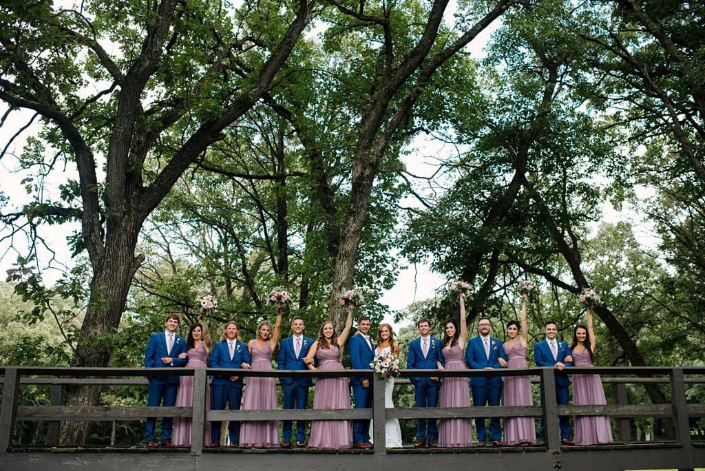 wedding party on a walking path bridge