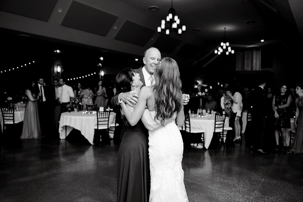 bride dances with father and mother at wedding reception
