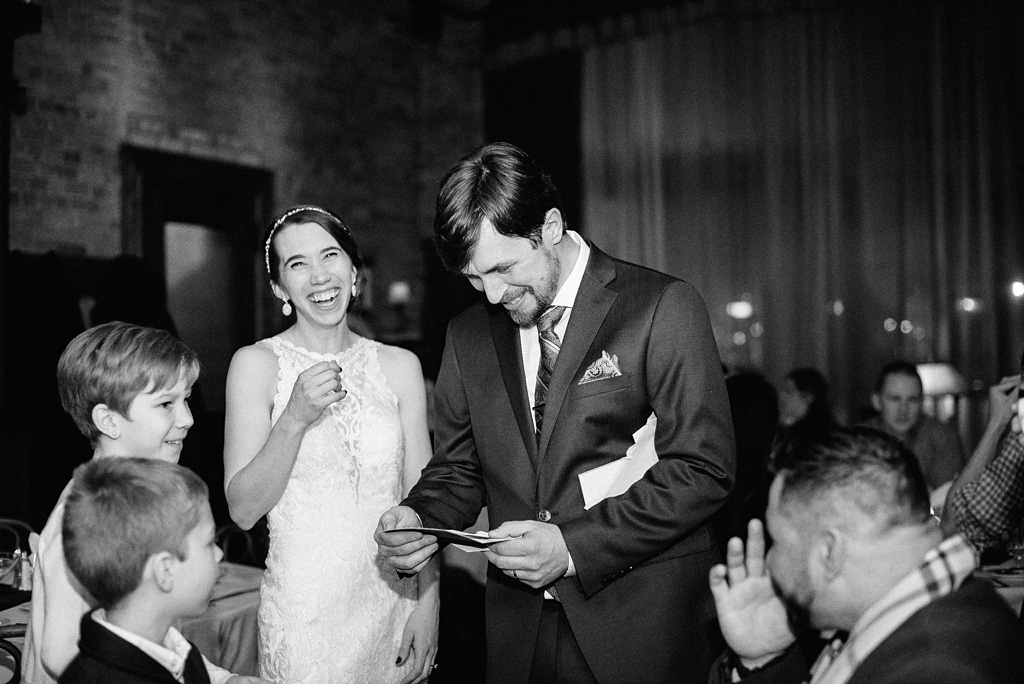 newlyweds laugh with guests at surprise wedding