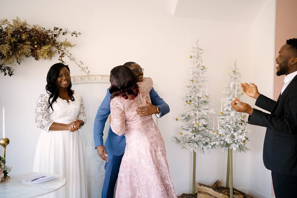 groom hugs family during minnesota micro wedding