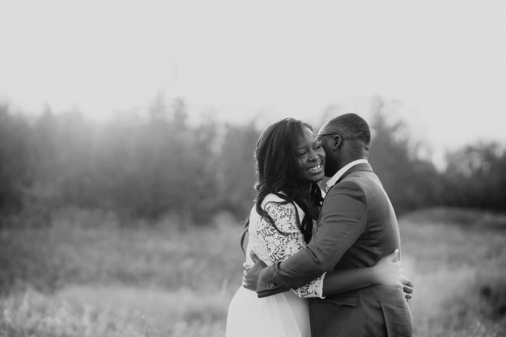 elopement couple in field at sunset
