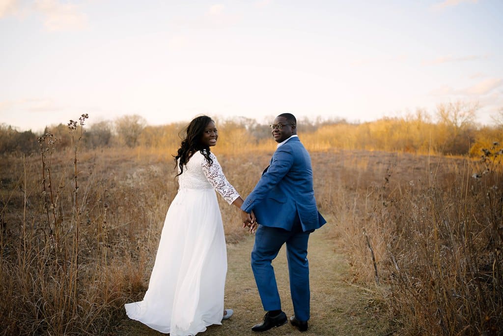 micro wedding celebration at sunset in golden field