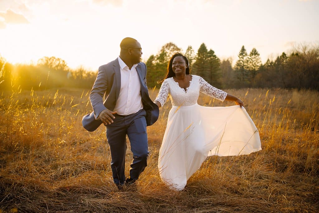sunset elopement couple running through field