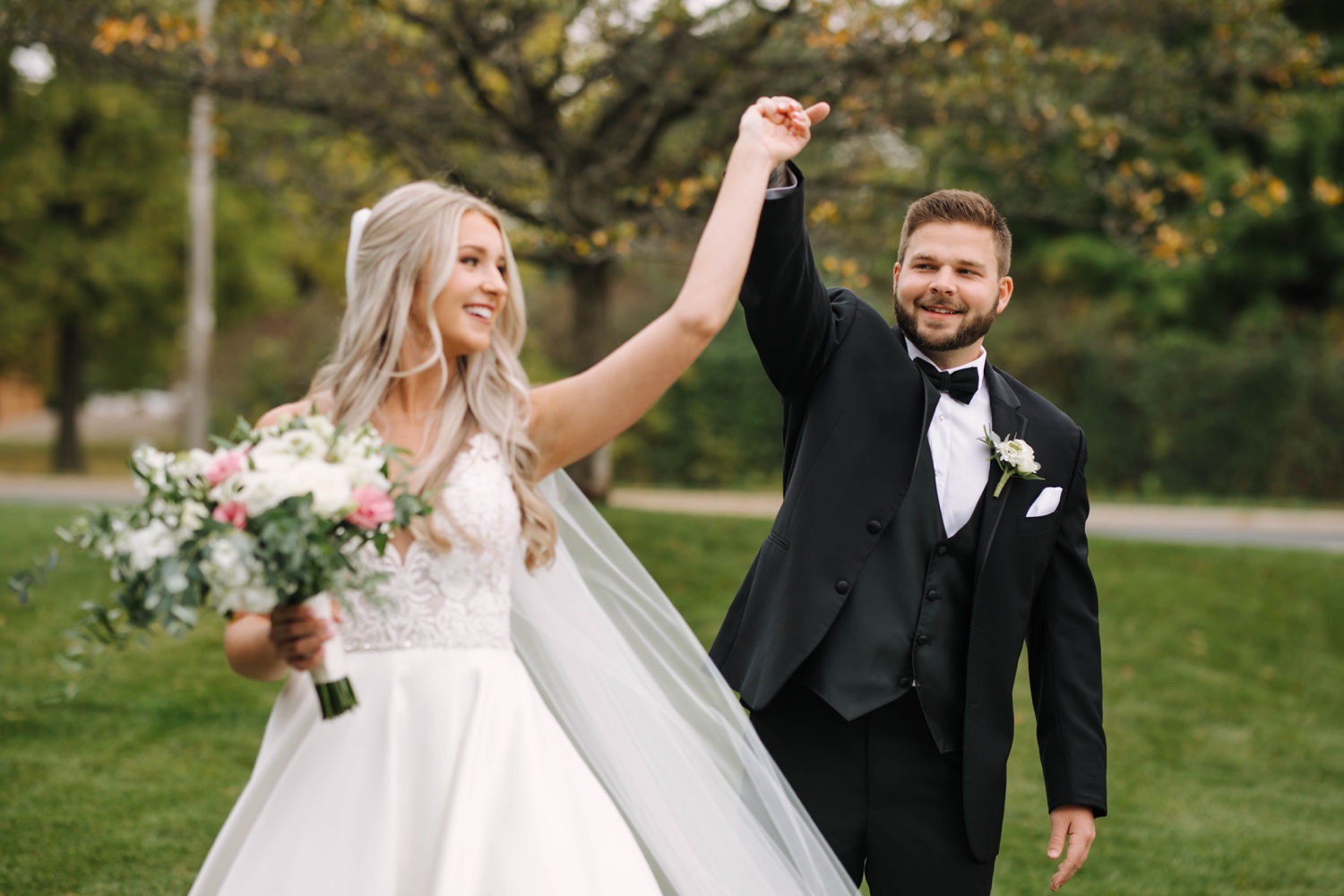 groom spins bride outside in minnesota fall