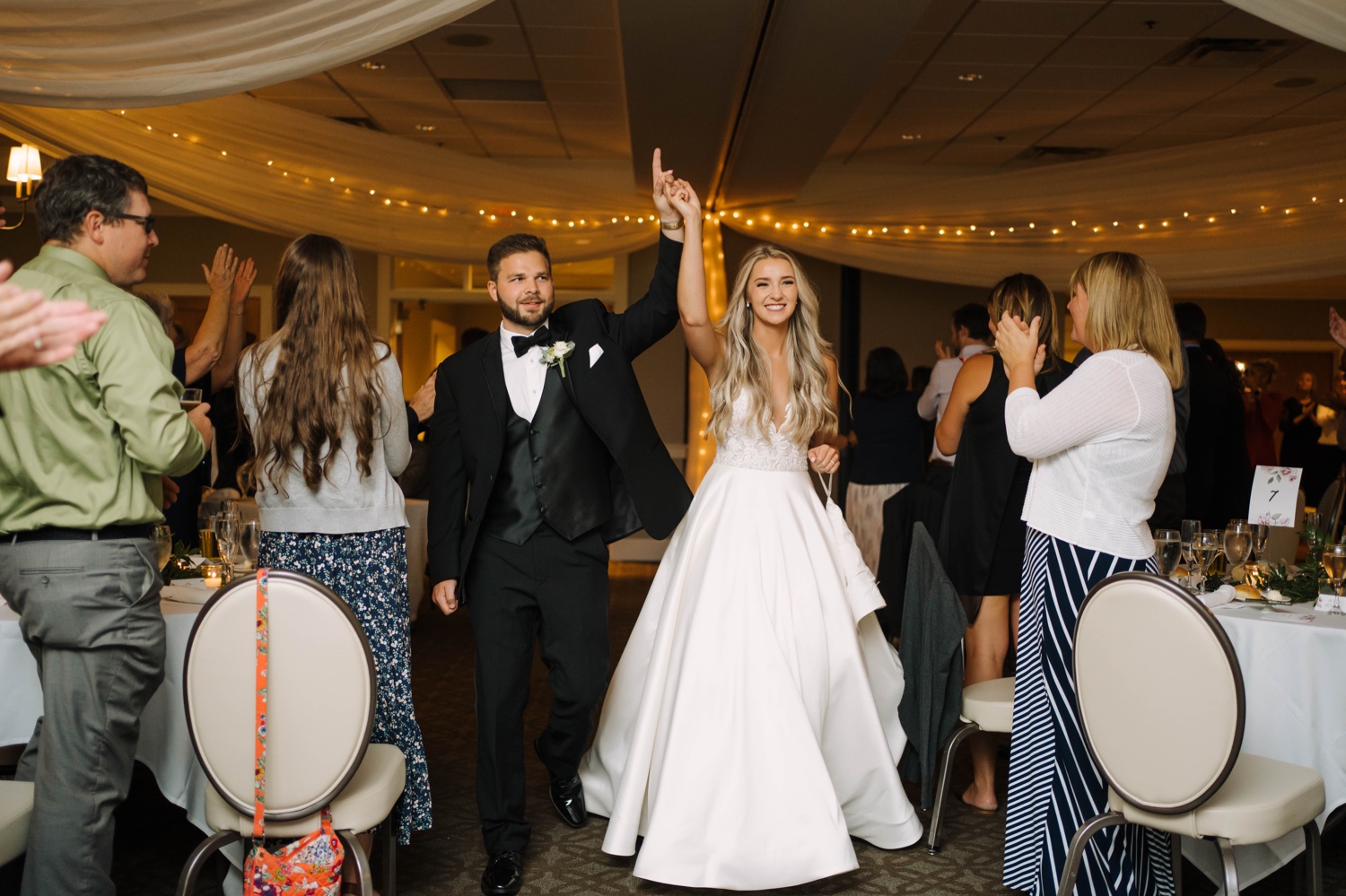 bride and groom enter reception at minnesota valley country club
