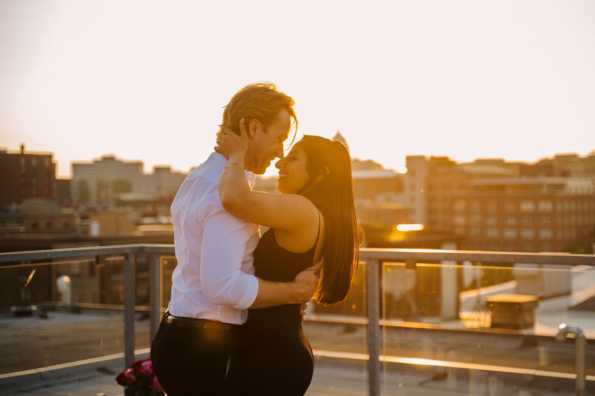 newly engaged couple embracing on st paul rooftop
