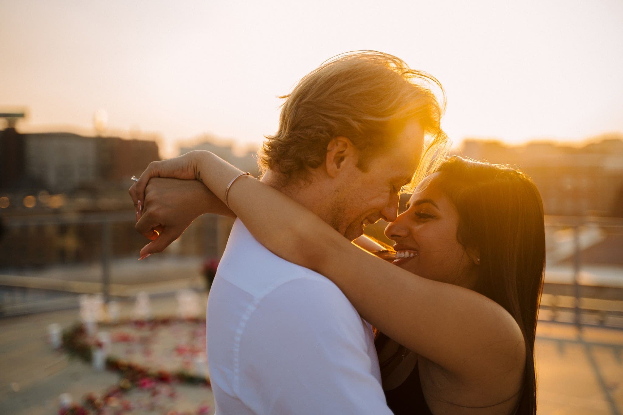 backlit sunset couple embracing on st paul roof