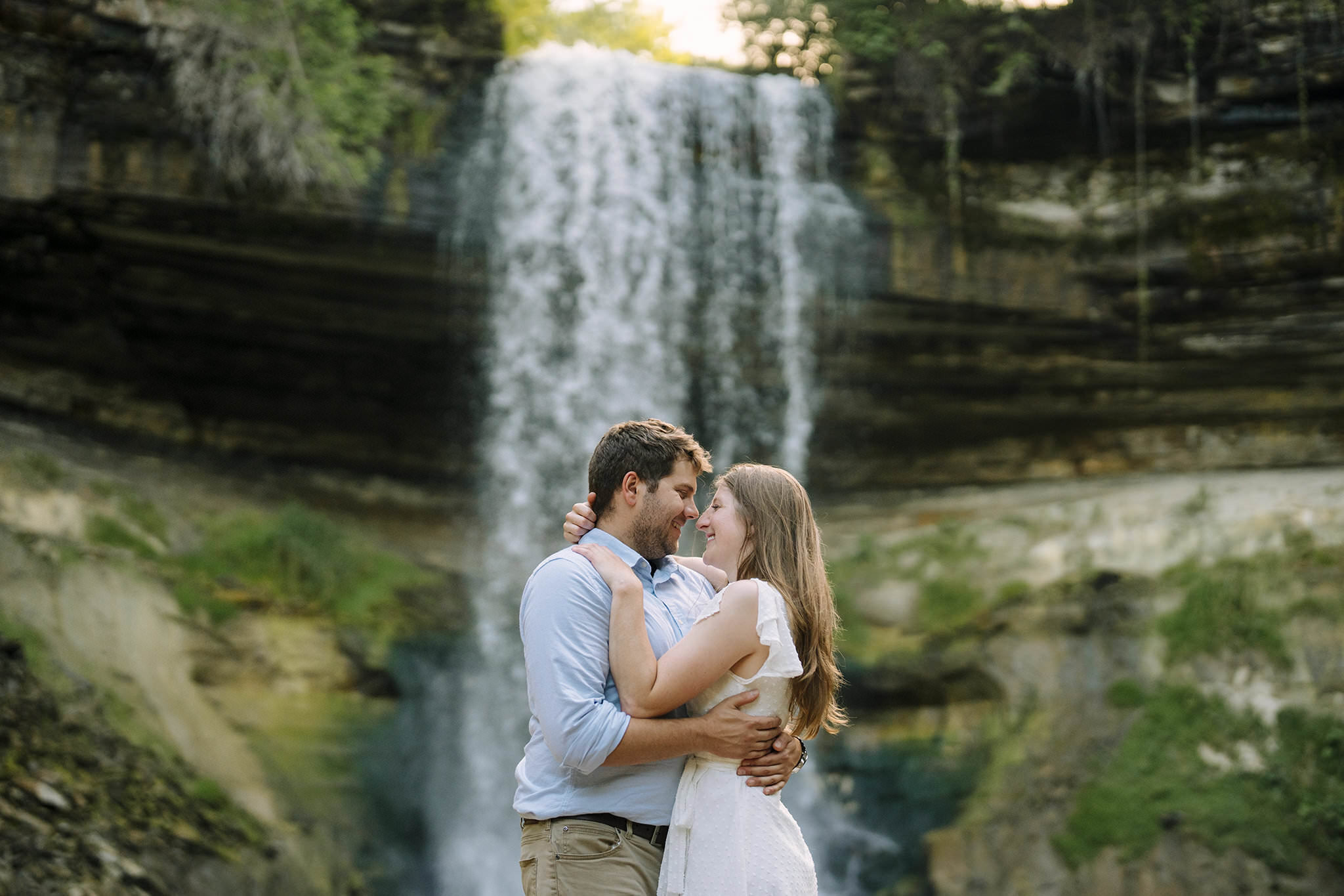 couple posing against Minneapolis Engagement Photo location Minnehaha falls 