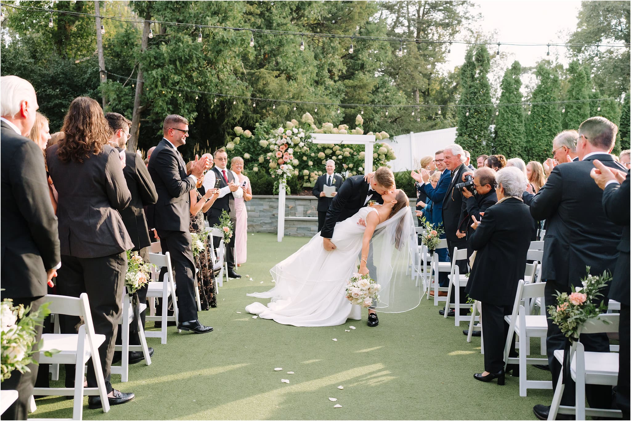 Ceremony kiss dipped in Minnesota wedding venue outdoors